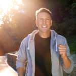 Middle-aged man smiling while running