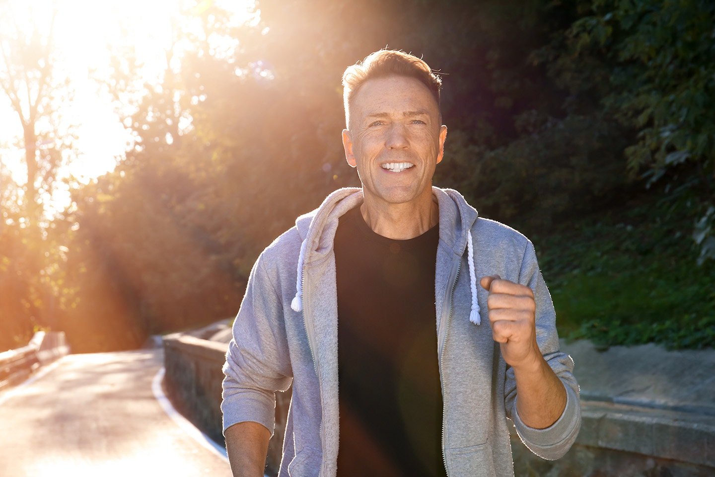 Middle-aged man smiling while running
