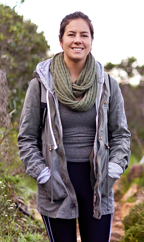 Woman on a hike wearing a coat and scarf