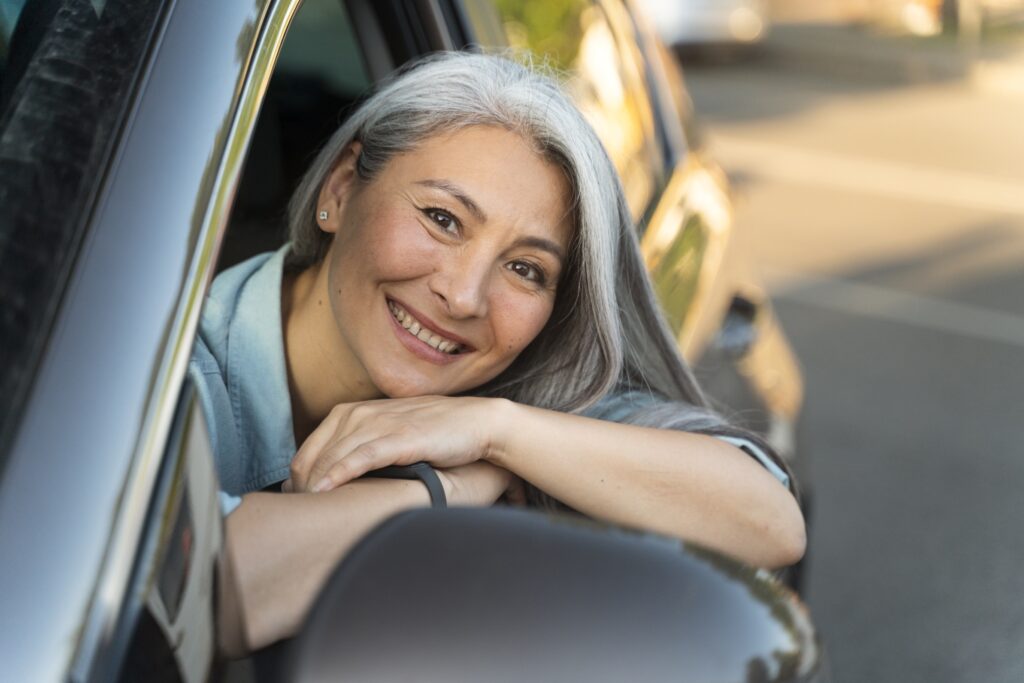 Happy woman on HRT in car